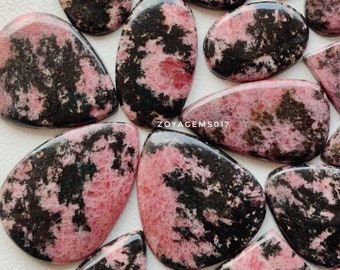 May include: A collection of pink and black gemstone cabochons. The stones have a unique, marbled pattern and are perfect for jewelry making.