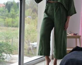 May include: A pair of green linen wide-leg pants with a drawstring waist.