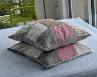 May include: Two patchwork pillowcases in shades of grey, pink, and white. The pillowcases are made of linen and have a rustic, farmhouse style.