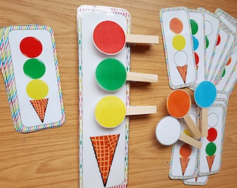 May include: A set of colorful ice cream cone matching cards with red, yellow, green, blue, and orange circles. The cards are designed for children to match the colors of the circles to the corresponding ice cream cone.