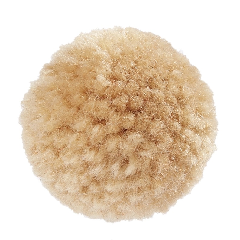 May include: A large, fluffy, beige pom pom. The pom pom is made of yarn and is round in shape.
