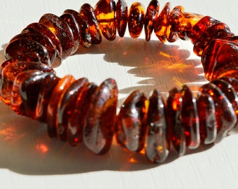 cognac cabochons Matt cabochons The bracelet is multicolored from natural Baltic amber Made of hard amber plates. white cabochons