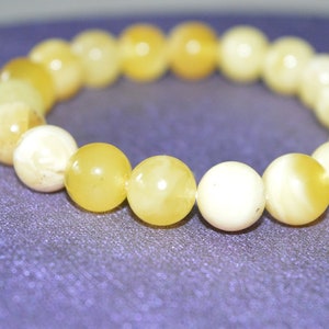 cognac cabochons Matt cabochons The bracelet is multicolored from natural Baltic amber Made of hard amber plates. white cabochons