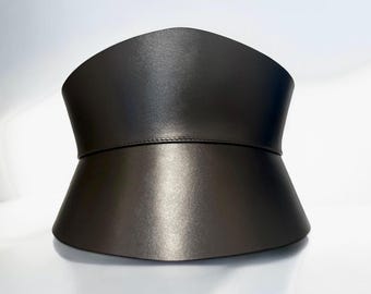 May include: A wide, black leather belt with a curved, pointed top and a flared bottom.