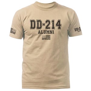 May include: Tan crew neck t-shirt with the text "DD-214 ALUMNI" in distressed black lettering. The design includes a US flag graphic above and below the text. A small US flag is also printed on the left sleeve.
