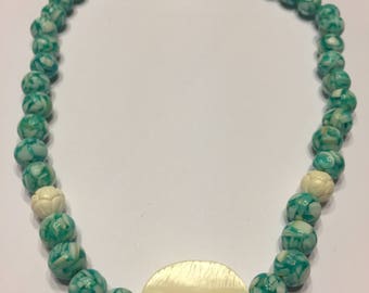 Mixed beaded necklace with mother of pearl focal stone.