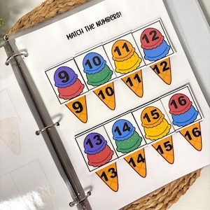 May include: A learning activity featuring ice cream cone graphics with numbers 9-16. The text "MATCH THE NUMBERS!" is at the top. The cones are in a binder on a woven mat. The ice cream scoops are in various colors.
