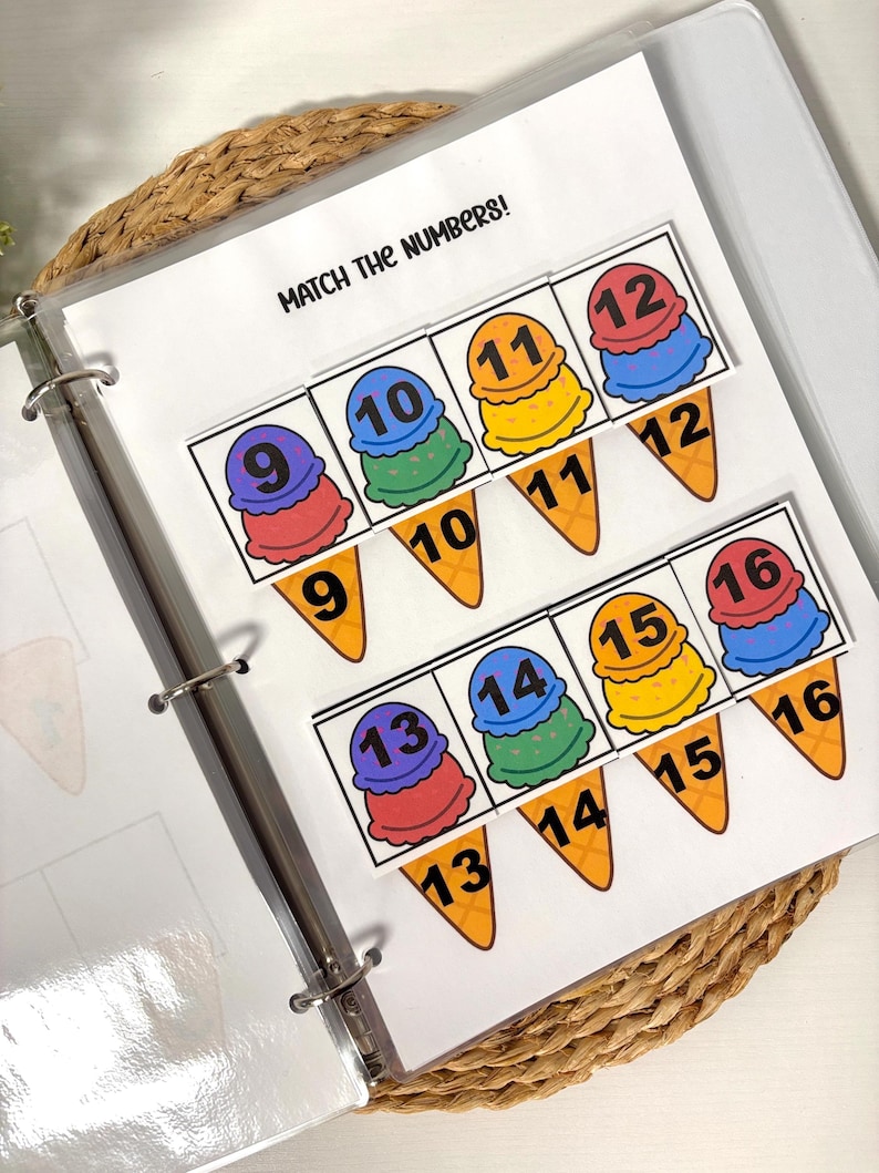 May include: A learning activity featuring ice cream cone graphics with numbers 9-16. The text "MATCH THE NUMBERS!" is at the top. The cones are in a binder on a woven mat. The ice cream scoops are in various colors.