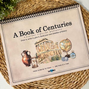 May include: A spiral-bound history timeline workbook titled A Book of Centuries. The cover features illustrations of the Parthenon, a globe, an hourglass, a clay vase, and a compass. Text includes Draw it, write it, glue it. Build your own timeline of history.