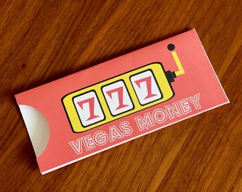 May include: A pink and yellow card with a slot machine graphic and the text "VEGAS MONEY".