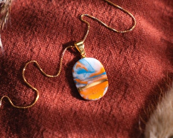 Marbled porcelain necklace in orange-blue, oval | Unique handmade ceramic jewelry | Silver 925 gold plated