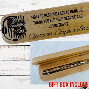 May include: A wooden pen box with a pen inside. The box is engraved with the words "FIRST TO RESPOND, LAST TO HANG UP. THANK YOU FOR YOUR SERVICE AND COMMITMENT." and "Operator Stephen Brooks." The box also features a police badge and the text "GIFT BOX INCLUDED."