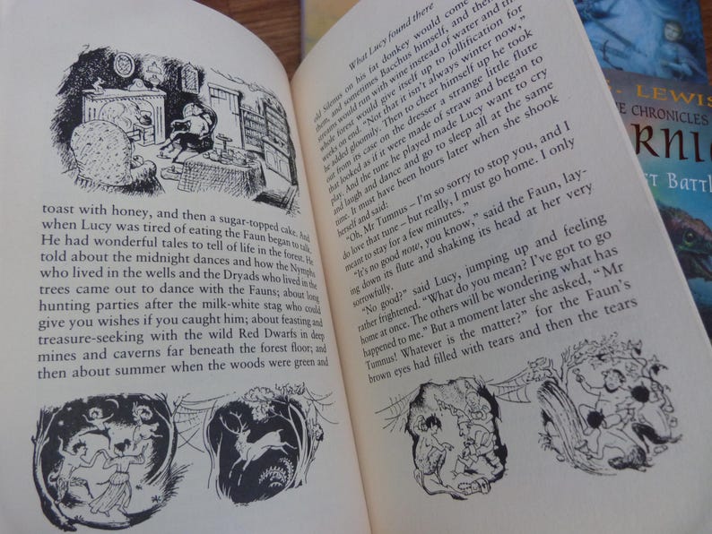 May include: Black and white illustration of a scene from a children's book. The illustration shows a faun playing a flute, a girl sitting on a chair, and a fireplace. The text in the image reads "What Lucy found there..."