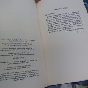 May include: A close-up of the dedication page of a book. The text reads "To Lucy Barfield" and includes a letter from C.S. Lewis to Lucy. The letter is dated 1953.