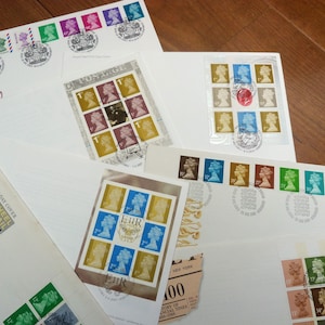 Collection of 12 GB Stamps First Day Covers QE2 Machin Definitives Inc Booklet Panes 1970-2010