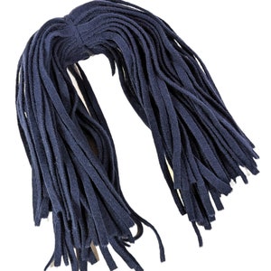 May include: A bundle of navy blue fabric strips, tied together at the top. The strips are long and thin, creating a fringe-like appearance. The fabric appears to be soft and flexible, suitable for crafting or embellishment projects.