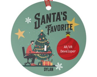 May include: Round Christmas ornament with a red ribbon. The ornament has a teal background with the text "SANTA'S FAVORITE" and a Christmas tree illustration. A red ornament with "AR/VR Developer" is also featured.