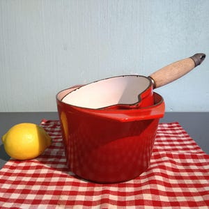 LeCreuset & NOMAR France. The cousins. Cast iron pots enamelled in the same red, 1970s, forever, well preserved. Vintage. Rare.age. rare