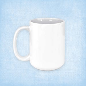 May include: A white ceramic mug with a large handle. The mug is empty and has a smooth, glossy finish.