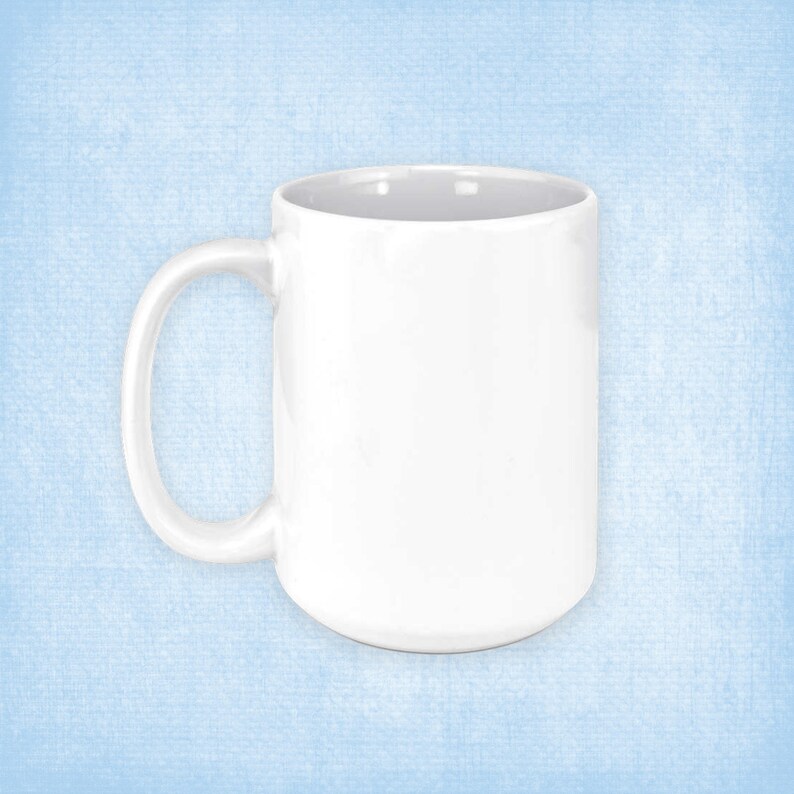 May include: A white ceramic mug with a large handle. The mug is empty and has a smooth, glossy finish.