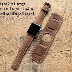 Peut inclure: Un bracelet de montre en cuir marron avec une montre connect&eacute;e argent&eacute;e et une manchette en cuir d&eacute;tachable. Le texte indique : With unique 2-in-1 design you can use the watch strap with or without the cuff band. Le bracelet poss&egrave;de une boucle.