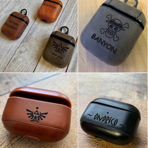 May include: A collection of leather earbud cases in various colors including tan, brown, and black. The cases feature custom laser-engraved text and graphics such as names, the text BANYON, ONDRICO, I love you, and symbols like a skull and triforce.