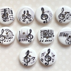 May include: Ten white round wooden buttons with black musical notes and a treble clef design. The buttons have two holes for sewing.
