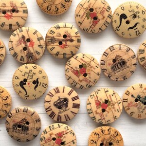 May include: A selection of round wooden buttons, each with a clock face design. The buttons feature Roman numerals, illustrations of landmarks, and floral accents. They have two sewing holes and a vintage appearance.