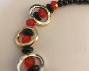 Bracelet - Black. red, and silver ovals