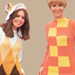 May include: Two women wearing colourful knitted sweaters. The woman on the left is wearing a white sweater with a diamond pattern in brown, orange, and yellow. She is also wearing a white beret with a brown pom-pom. The woman on the right is wearing a pink sweater with a checkerboard pattern in yellow and pink.