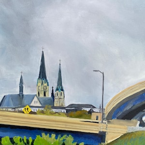 May include: A painting of a cityscape with a highway overpass in the foreground. The overpass is painted in shades of brown and blue. In the background, there are three church steeples painted in black and white against a cloudy gray sky.