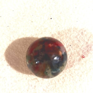 May include: A white ceramic mug with a black handle and the text "But First, Coffee" in a bold, black font. The mug is set against a neutral background, highlighting its simple design.