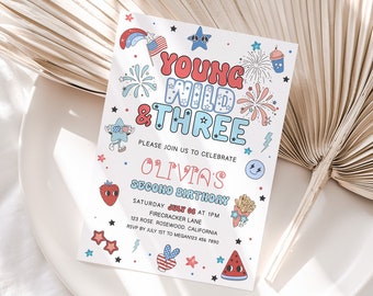 May include: A white invitation card with the text "Young Wild & Three" in red and blue, featuring illustrations of fireworks, stars, and a smiling face. The card is for Olivia's second birthday, with the date and location details.