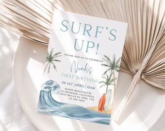 May include: A birthday invitation with the text "SURF'S UP!" in teal. The invitation features watercolor illustrations of a wave, palm trees, and surfboards. The invitation is for Noah's first birthday.
