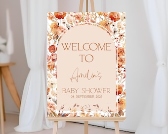 May include: Welcome to Amelia's Baby Shower sign with a floral design in shades of orange, yellow, and white. The sign is on a wooden easel and has the date 08 September 2025.