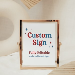 May include: A gold-framed sign with the text "Custom Sign" in red and blue lettering. The sign also includes the text "Fully Editable make unlimited signs" in black lettering.