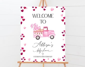 May include: Pink welcome sign with a pink truck carrying hearts and the text "Welcome to Addison's Baby Shower Saturday 11th February". The background is white with pink hearts.