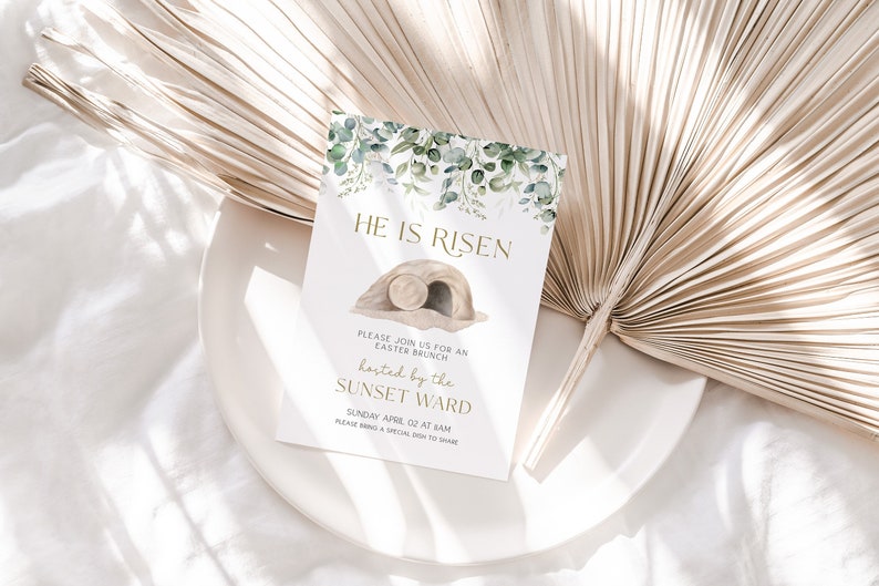 May include: A white card with green watercolor leaves and a gold inscription that reads "He is Risen". The card also includes a watercolor illustration of a stone tomb with a rolling stone. The text below the illustration reads "Please join us for an Easter Brunch hosted by the Sunset Ward, Sunday April 02 at 9am. Please bring a special dish to share."