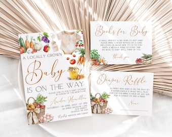 May include: A baby shower invitation with a watercolor illustration of a basket of vegetables and a jar of honey. The invitation says "A Locally Grown Baby is on the Way" and includes the date, time, and location of the shower. There are also two cards for a book and diaper raffle.