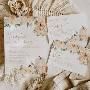 May include: A baby shower invitation with a watercolor pumpkin and floral design. The invitation reads "A Little Pumpkin is on the way" and includes the names Maddie & Anthony, the date and time of the shower, and the location. There are also cards for a diaper raffle and books for baby.