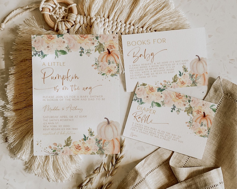 May include: A baby shower invitation with a watercolor pumpkin and floral design. The invitation reads "A Little Pumpkin is on the way" and includes the names Maddie & Anthony, the date and time of the shower, and the location. There are also cards for a diaper raffle and books for baby.