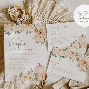 May include: A baby shower invitation with a pumpkin theme. The invitation features a watercolor illustration of pumpkins, flowers, and leaves. The text on the invitation reads "A Little Pumpkin is on the way".
