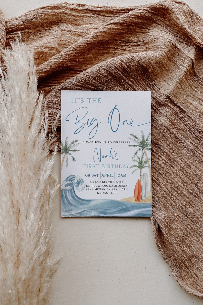 May include: A blue and white invitation card with a beach theme. It says "It's the Big One" and "Noah's First Birthday". The date is 08 SAT APRIL 10AM. The location is Mason Beach House, 123 Redwood, California. RSVP by April 5th to 123 456 7890.