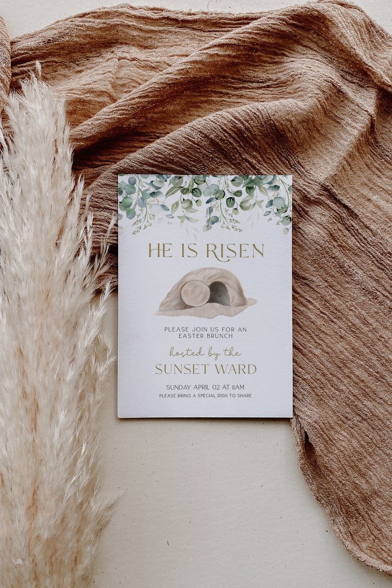 May include: A white card with green foliage and a gold inscription that reads "HE IS RISEN". The card also includes a drawing of a stone tomb with a rolled-away stone. The text below the drawing reads "PLEASE JOIN US FOR AN EASTER BRUNCH hosted by the SUNSET WARD SUNDAY APRIL 02 AT 11AM PLEASE BRING A SPECIAL DISH TO SHARE".