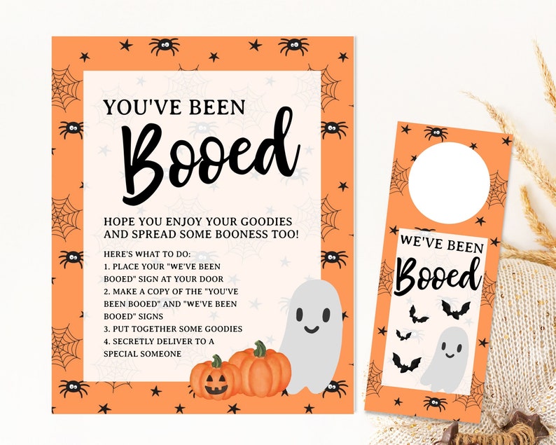 May include: Printable Halloween "Booed" door hanger and instructions. The orange and black door hanger features a ghost and bats. The instructions include a list of steps for a "Booed" game.