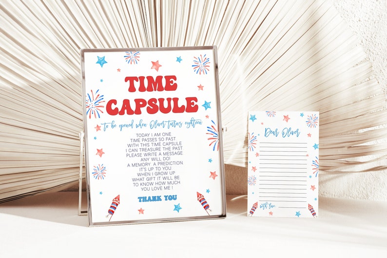 May include: A white sign with red and blue fireworks and stars, with the text "TIME CAPSULE to be opened when Oliver turns eighteen".  The sign also includes instructions for writing a message to be opened in the future.  A smaller white card with red and blue fireworks and stars says "Dear Oliver".