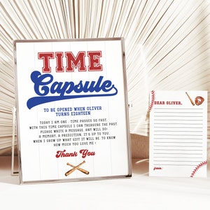 May include: A white sign with blue and red text that reads "TIME Capsule" and "To be opened when Oliver turns eighteen."  The sign also includes instructions for writing a message in the time capsule.  A white card with red and blue baseball stitching and the text "Dear Oliver." is also included.