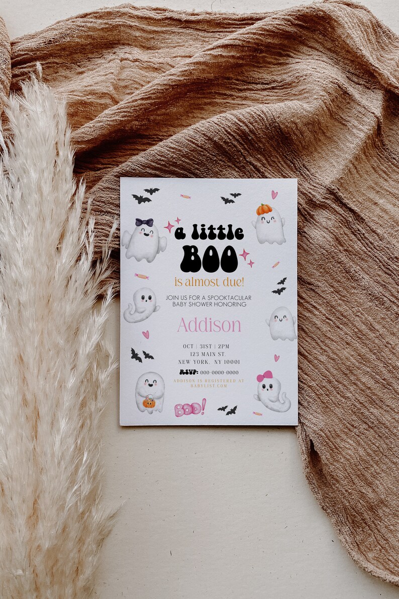 May include: A white baby shower invitation with a Halloween theme. The invitation features a cartoon ghost with the text "a little BOO is almost due!" and the name "Addison". The invitation also includes the date, time, and location of the baby shower.
