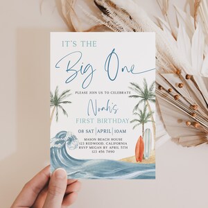 May include: A blue and white invitation with a watercolor wave design and palm trees. The text reads "It's the Big One" and "Noah's First Birthday". The invitation includes the date, time, location, and RSVP information.