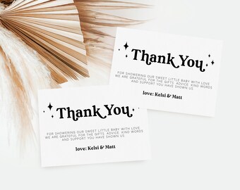 May include: Two white thank you cards with black text and stars. The text reads "Thank You" and "For showering our sweet little baby with love. We are grateful for the gifts, advice, kind words and support you have shown us. Love: Kelsi & Matt."